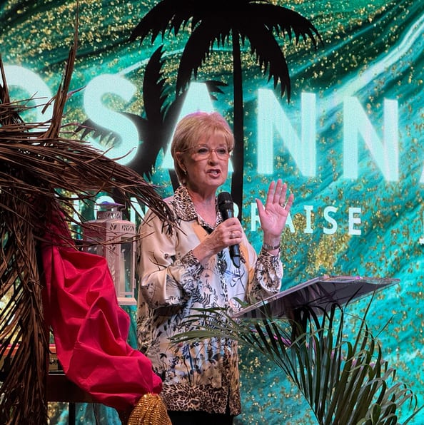 Pastor preaching with a microphone on stage during a City on a Hill Church service